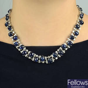 A sapphire cabochon and brilliant-cut diamond collar necklace.