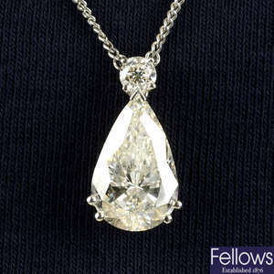 An 18ct gold pear-shape diamond pendant, with brilliant-cut diamond surmount, on chain.