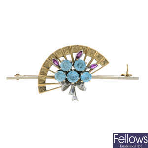 A mid 20th century 9ct gold blue zircon and ruby fan bi-colour brooch, by Alabaster and Wilson.