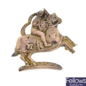 A jousting man on a horse back brooch.