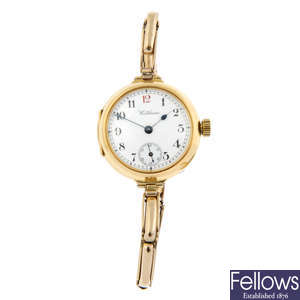 WALTHAM - a 18ct yellow gold bracelet watch (29mm) with a white metal Bucherer ring watch.