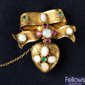A mid 19th century gold opal, emerald and ruby bow brooch, suspending a similarly-set heart locket.