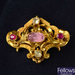 A mid 19th century gold pink topaz, ruby and chrysoberyl scrolling foliate brooch, with glazed hair locket reverse.