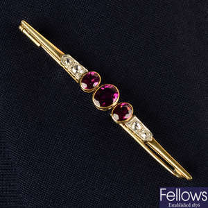 An early to mid 20th century 14ct gold garnet and old-cut diamond bar brooch.
