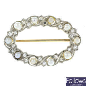 An early 20th century gold diamond and seed pearl scrolling wreath brooch.