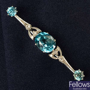 A mid 20th century palladium blue zircon and single and old-cut diamond bar brooch.