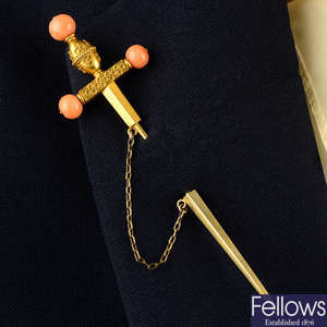 A mid to late 19th century gold cannetille sword pin, with coral bead highlights.