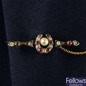 A late Victorian silver and gold, old-cut diamond, ruby and pearl horseshoe brooch.