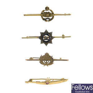 Four mid 20th century gold military brooches.