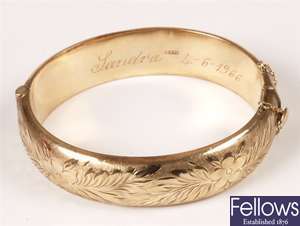 9ct gold hinged bangle, with floral engraving.