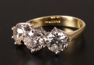 18ct gold three stone diamond ring with an