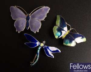 Seven silver enameled brooches, to include four