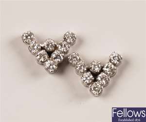 A pair of 'V' shape stud earrings each set with