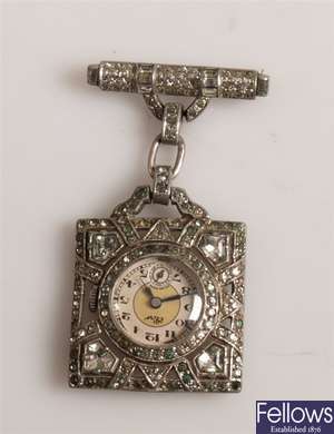 A metal brooch/fob watch with square shaped