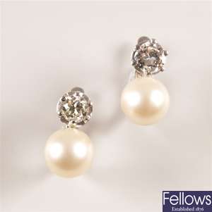 A pair of cultured pearl and claw set diamond
