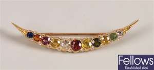 Open crescent brooch set with multi coloured