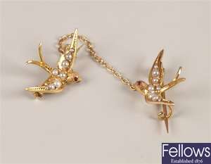 A pair of seed pearl set swallow brooches with