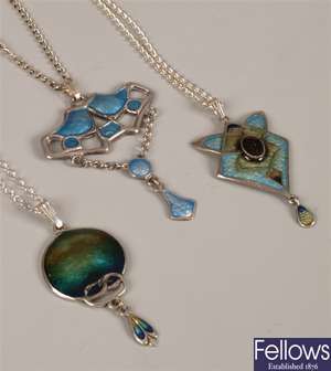 Three silver enamelled abstract design pendants.