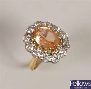 Oval yellow topaz and diamond cluster ring. with