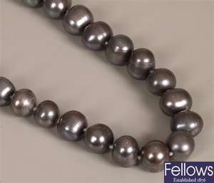 A baroque black pearl necklace. Length -