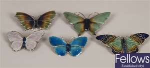 Five sliver enamelled butterfly design brooches.
