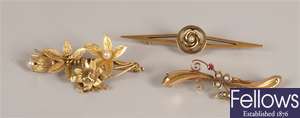 Three 15ct gold brooches to include a flower