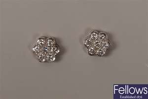 A pair of 18ct white gold seven stone round