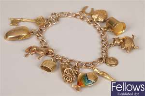 9ct gold curb link charm bracelet with twelve