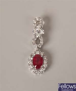 18k white gold ruby and diamond pendant with a