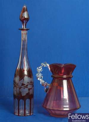 A Victorian cranberry glass jug with clear glass