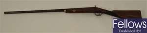 An antique flintlock rifle the wooden stock with
