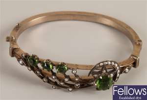 Green stone and seed pearl bangle in a crescent