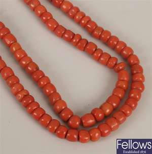 Double row coral bead necklace, with held hand