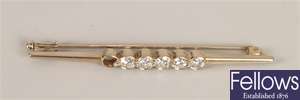 Diamond bar brooch with six collet set round