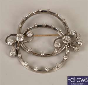 Diamond circular design brooch with two entwined