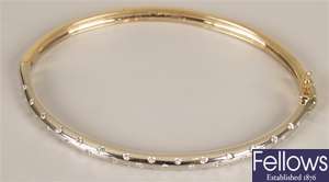 9ct gold diamond hinged bangle with inlaid round