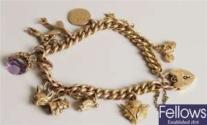 9ct gold curb link charm bracelet with ten charms