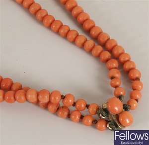 Two row graduated coral bead necklet on a metal