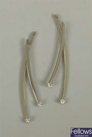 A pair of 18ct white gold diamond set cross over