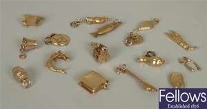 Sixteen assorted 9ct gold charms to include a