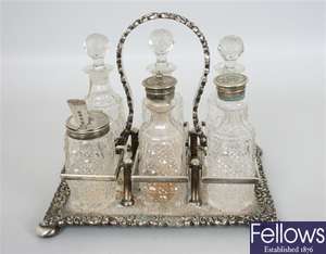 A cut glass and silver plated six bottle cruet