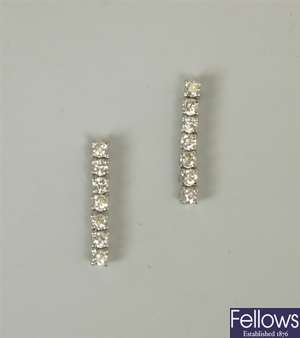 A pair of 18ct white gold seven stone round