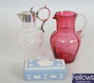 A Victorian cranberry glass jug with clear loop