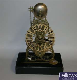 A late 19th century brass skeleton timepiece, the