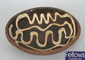 An antique pottery bowl with slip glazed