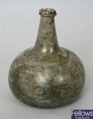 An early 18th century green glass onion shaped