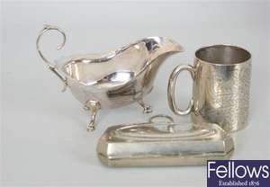 A small silver sauceboat with shaped rim,