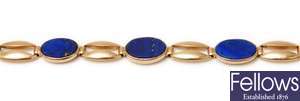 An oval panel link bracelet with five oval lapis