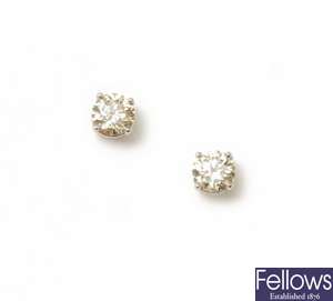 A pair of single stone diamond stud earrings with
