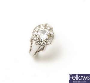 An 18ct white gold diamond cluster ring, the
